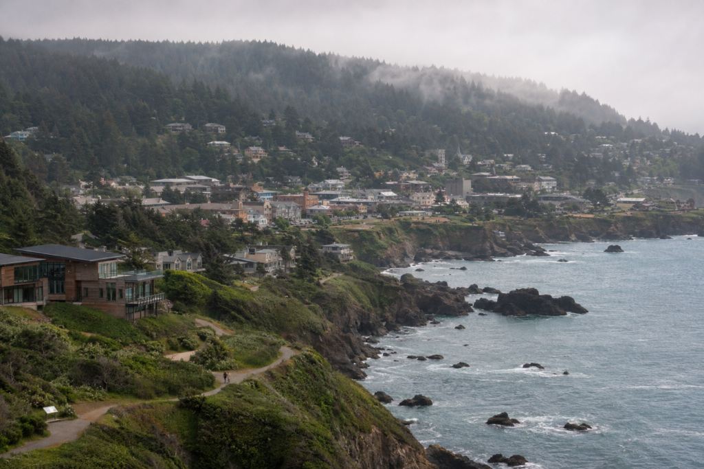 Bastinna, a temperate forested coastline of cliffs and hillside homes north of Morphelio